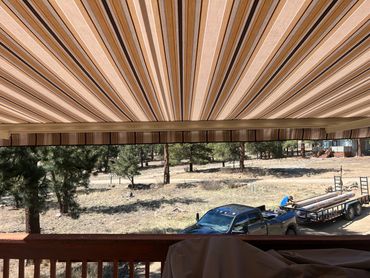 Striped retractable patio awning