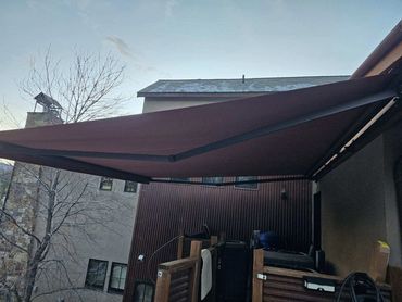 Brown retractable awning over a window