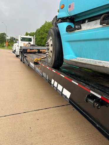Scott’s Towing flatbed hauling a semi-truck for transport on Highway 61 near Hannibal, MO.