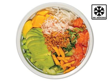 Colorful poke bowl with fresh avocado, mango, salmon, and toppings.