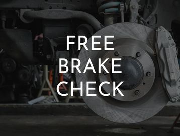 An up-close view of a car's brakes with "Free Brake Check" in white lettering over the photo.
