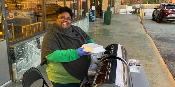 A Challenges Inc SC volunteer, providing hot meals at the mobile unit.