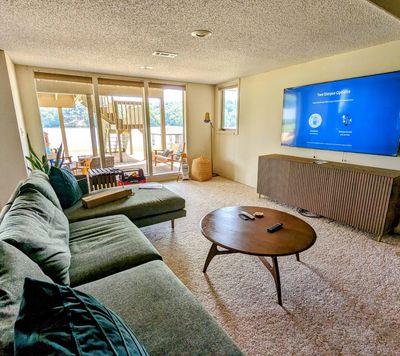 A comfortable living room with big windows.