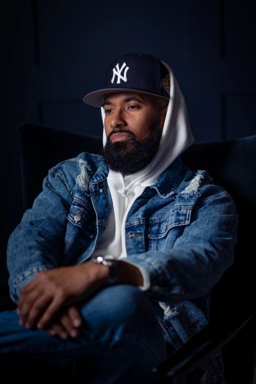 Man wearing a New York Yankees cap and denim jacket.producer branding photo shoot. NYC Headshot & Branding Photographer | Taisha Marie Photos