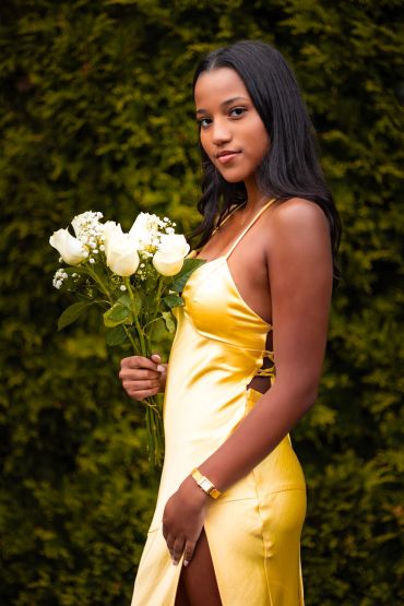Young woman in a yellow dress holding white roses.NYC Graduation & Prom Photographer | Taisha Marie Photos