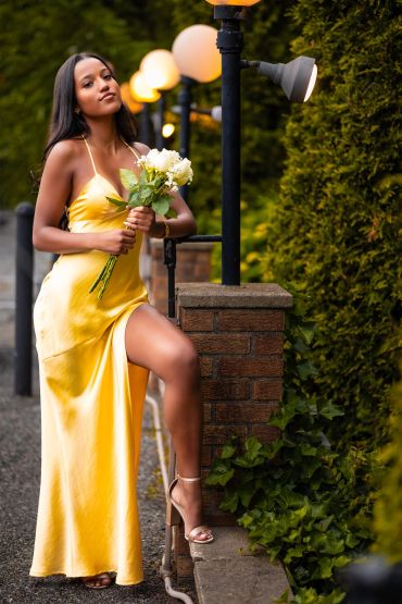 Woman in a yellow dress holding flowers outdoors for prom photos. Taisha Marie Photos , Bronx, NY, New York City