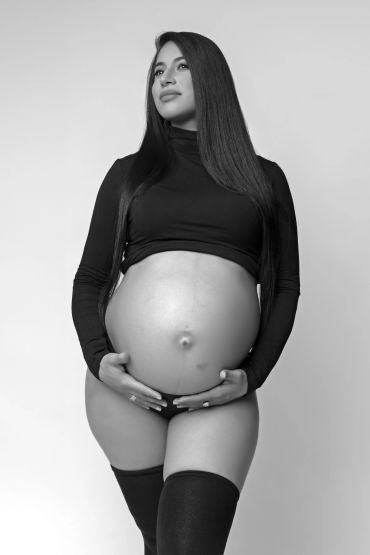 Pregnant woman holding her belly in a black and white maternity portrait photo.Taisha Marie Photos , Bronx, NY, New York City