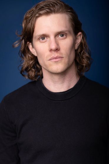 Man with wavy hair in black shirt. acting headshots. NYC Headshot & Branding Photographer | Taisha Marie Photos