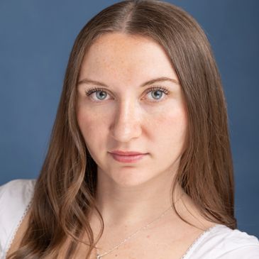 Portrait of a young woman with blue eyes and brown hair.NYC Photography Pricing | Taisha Marie Photos