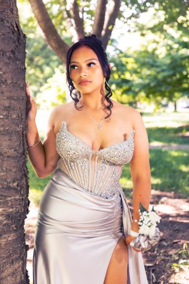 Young woman in an elegant silver dress outdoors.NYC Graduation & Prom Photographer | Taisha Marie Photos