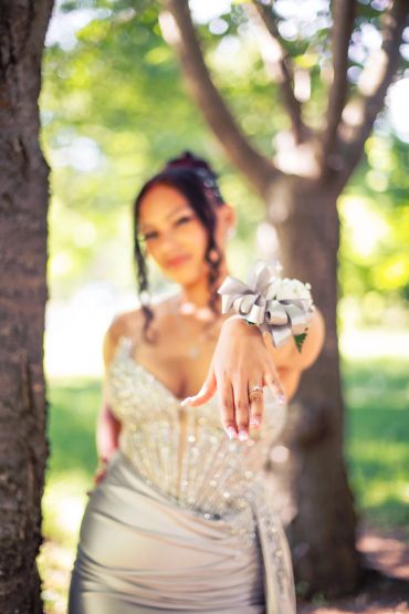 Young woman showing off her ring with a blurred background.NYC Graduation & Prom Photographer | Taisha Marie Photos