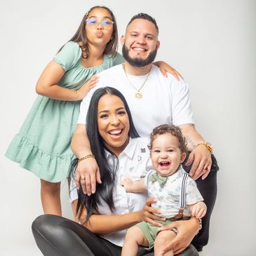 Happy family portrait with parents and two children smiling together. NYC Photography Pricing | Taisha Marie Photos