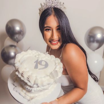 Young woman celebrating 19th birthday with a cake and wearing a crown. NYC Photography Pricing | Taisha Marie Photos