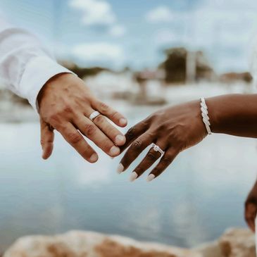 A couple's hands reaching out, showing wedding rings.NYC Photography Pricing | Taisha Marie Photos