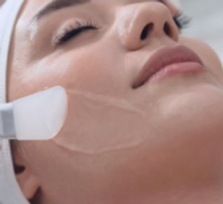 A woman is relaxing on her Glycolic Acid Peel by Blossoms Beauty Skincare in Fort Lauderdale, FL