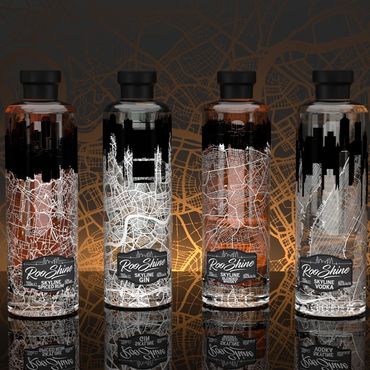 Six Roo Shine liquor bottles with city skyline and map designs.