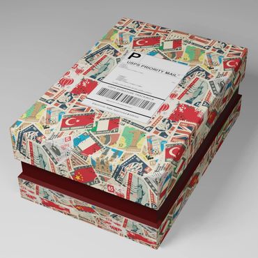 Decorative box covered with international postage stamp designs and a USPS Priority Mail label.