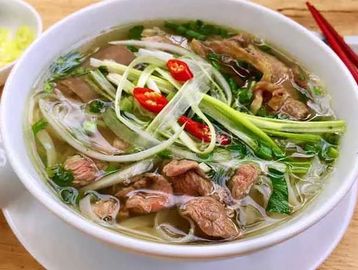 Traditional Vietnamese noodle soup with a deeply flavorful 24-hour broth, served with rice noodles,