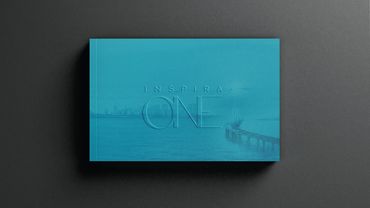Blue book cover titled 'Inspira One' with a city skyline and bridge background.