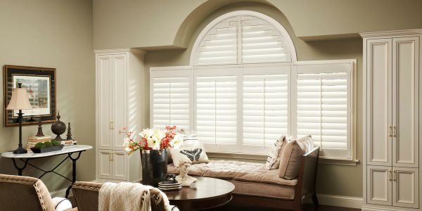 Cozy living room with a window seat and white shutters.