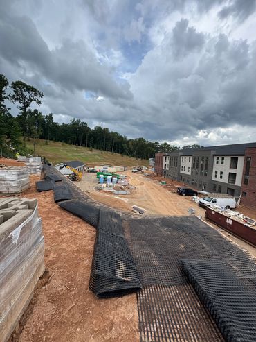 Construction site with cloudy sky and building in progress.