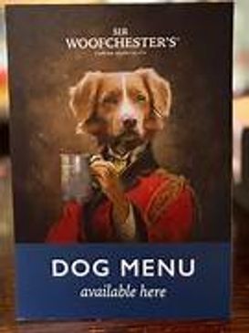 A humorous dog menu sign featuring a dog dressed in regal attire.