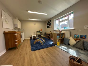 Changing station with small kitchenette. Kitchen role play area and book shelfs