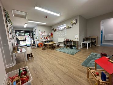 Main room with children’s toy trains, doll house children size table and chairs