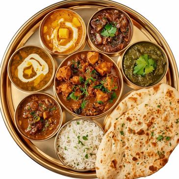 Punjabi veg thali with dal makhni, paneer, mushroom, chole, saag, kadhi, rice and garlic naan