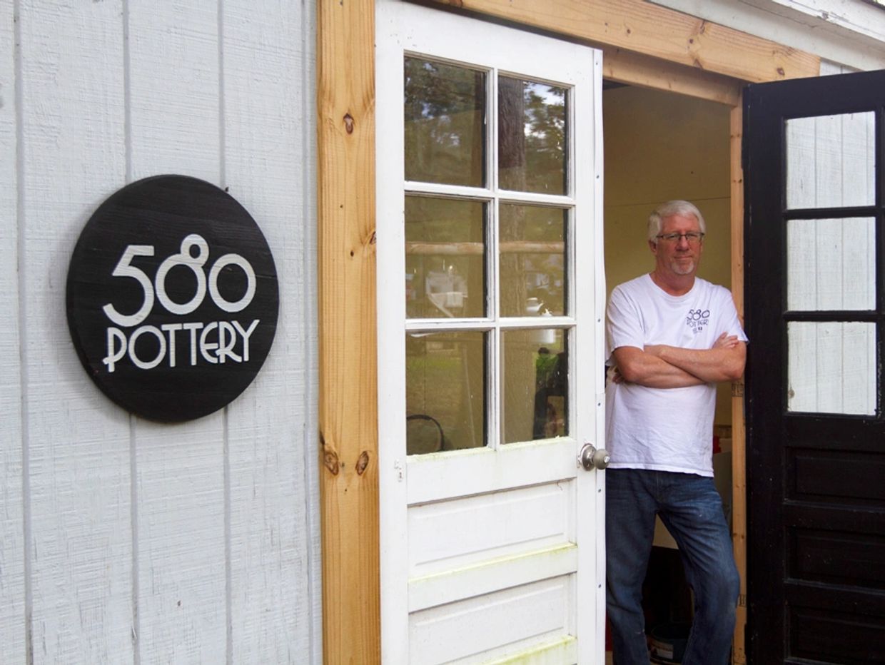 Sam the potter standing at the door of 580 Pottery, makers of functional pottery near Ashland, Virgi