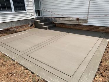 Deck Removal and Concrete Patio with steps installation. Hand tooled expansion joints.