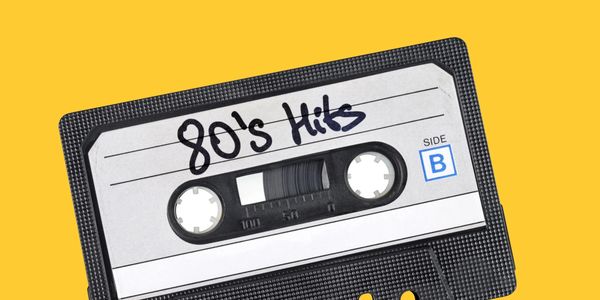 Cassette tape image with "80's hits" handwritten on it over cheerful yellow background.