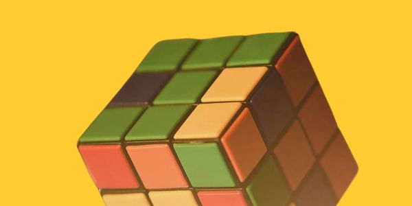 Rubix Cube image over cheerful yellow backdrop.