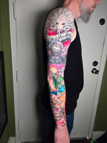 Colorful full sleeve tattoo featuring fantasy characters and creatures on a man's arm.