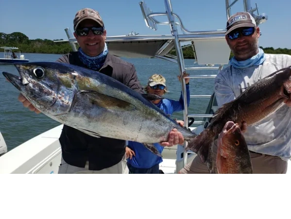 clients with tuna and mango snapper they caught on deep sea fishing charter