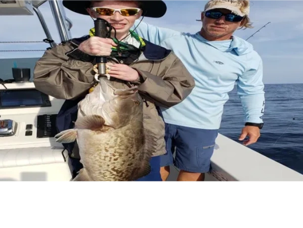 kid caught this nice grouper on a deep sea fishing trip fishing charter