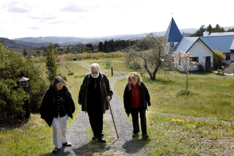 Starcross Founders, Sister Marti, Brother Toby, and Sister Julie walking to the chapel.