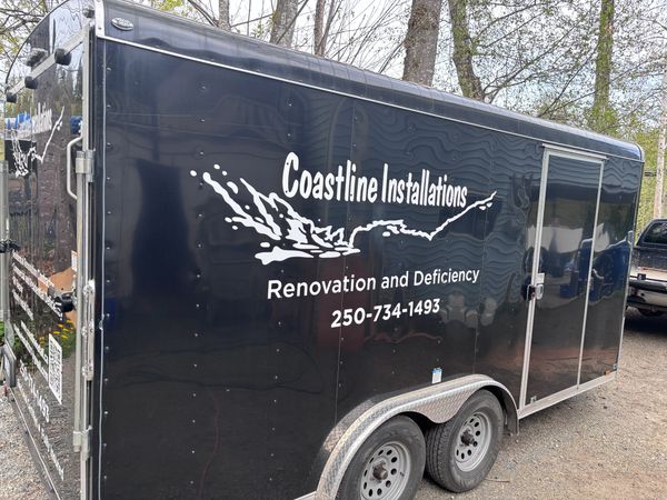 Black trailer with Coastline Installations signage.