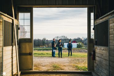 Family standing in front of a barn
