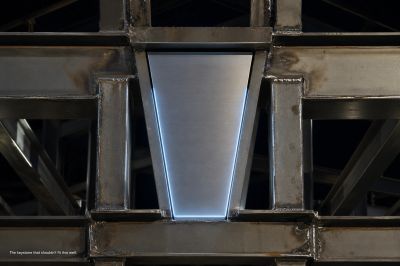 Metal structure with welded joints and illuminated panel.
