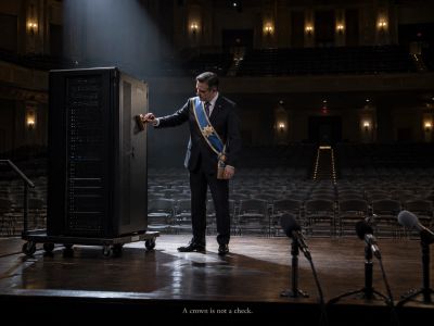 Lone sashed figure stamps approval alone on an empty stage