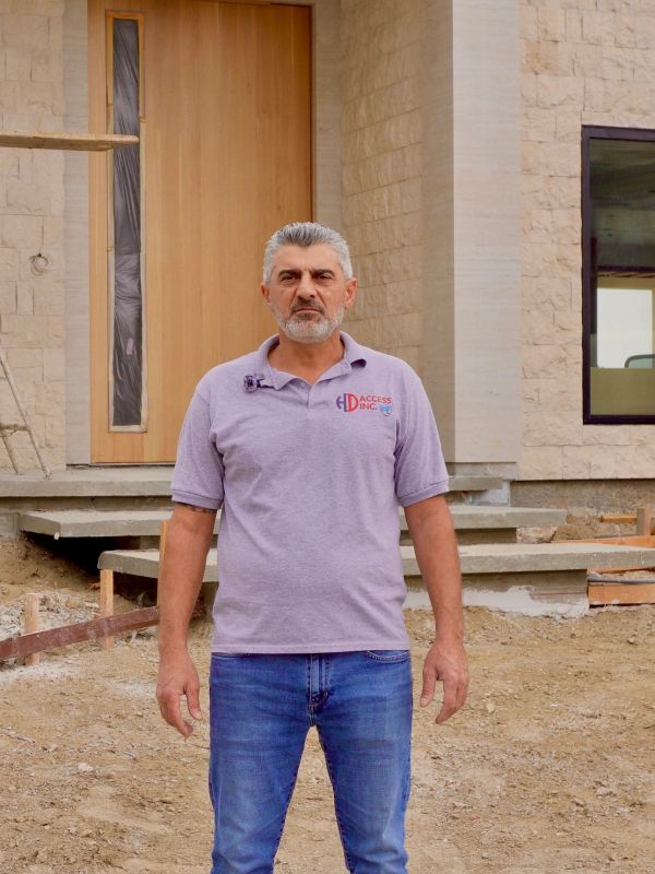 Man standing outside a building under construction.