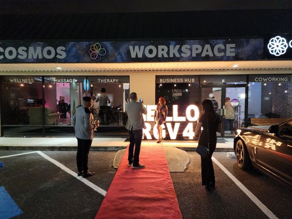 People in red carpet event at store front office space