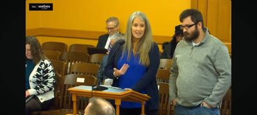 Mom and son standing behind lectern.