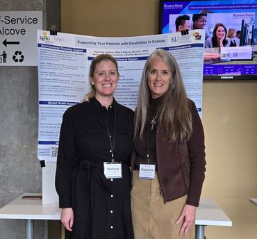 Two women standing in front of research poster.
