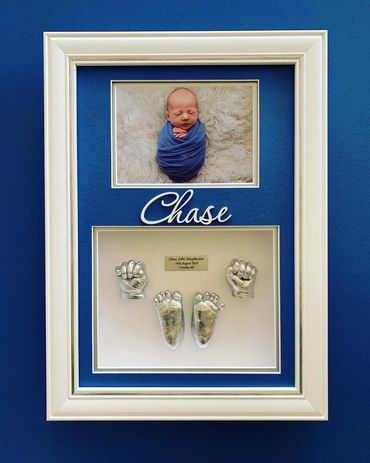 Baby hand and feet casting with small name.