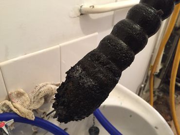 Debris removed from old heating system during power flushing