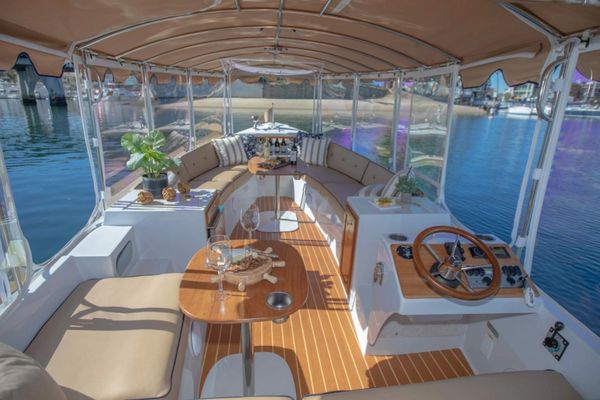 Cozy boat interior with curved seating and wooden accents.
