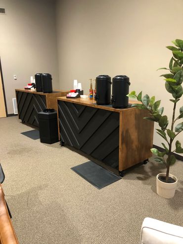 Two custom built coffee carts with a modern black and dark wood design, built by Henry's.