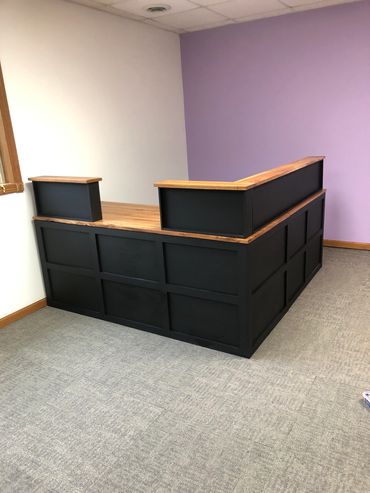 Custom modern black and hardwood desk for an office, built by Henry's Legacy Woodworking.